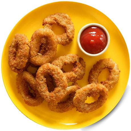 Prime Range Fresh Breaded onion rings on a yellow plate with a side of ketchup.